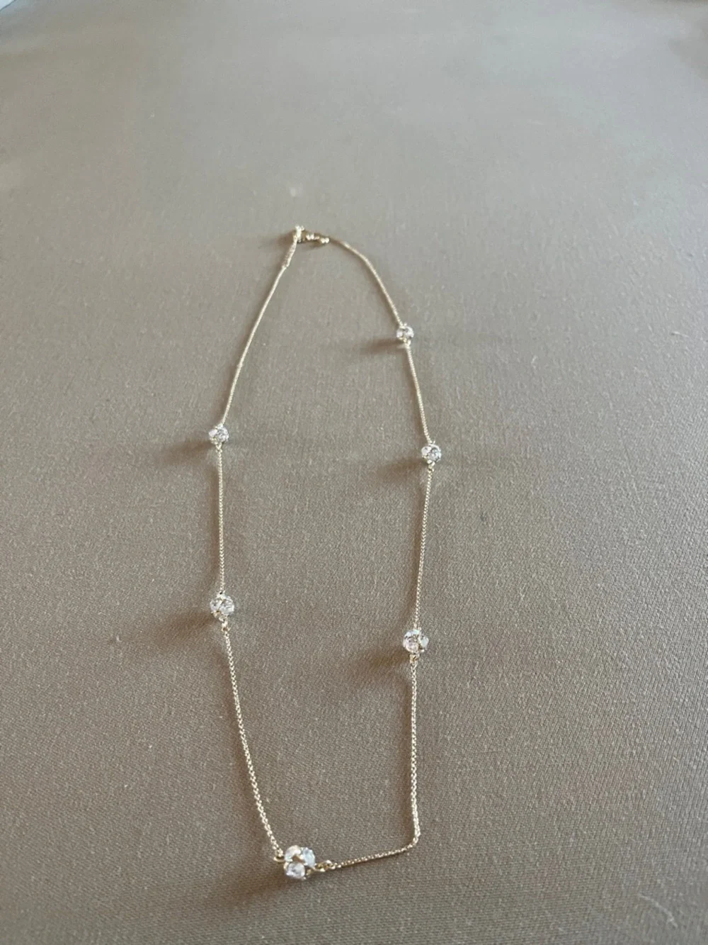 Kate Spade long golden necklace with crystal beads.